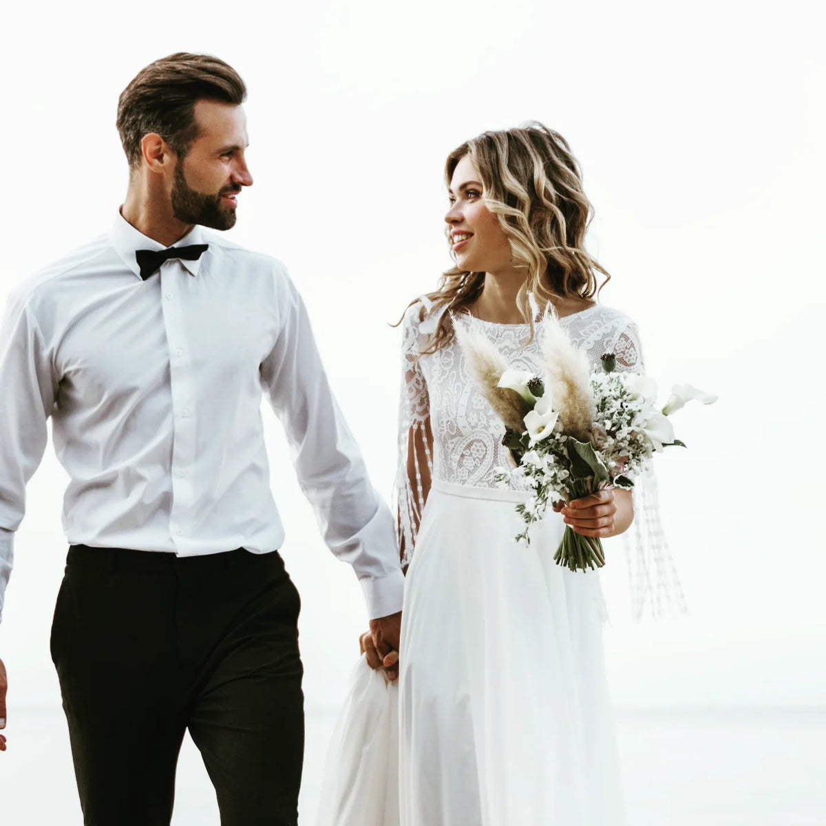 Bride with half-up curls beside the groom – NED.K HAIR